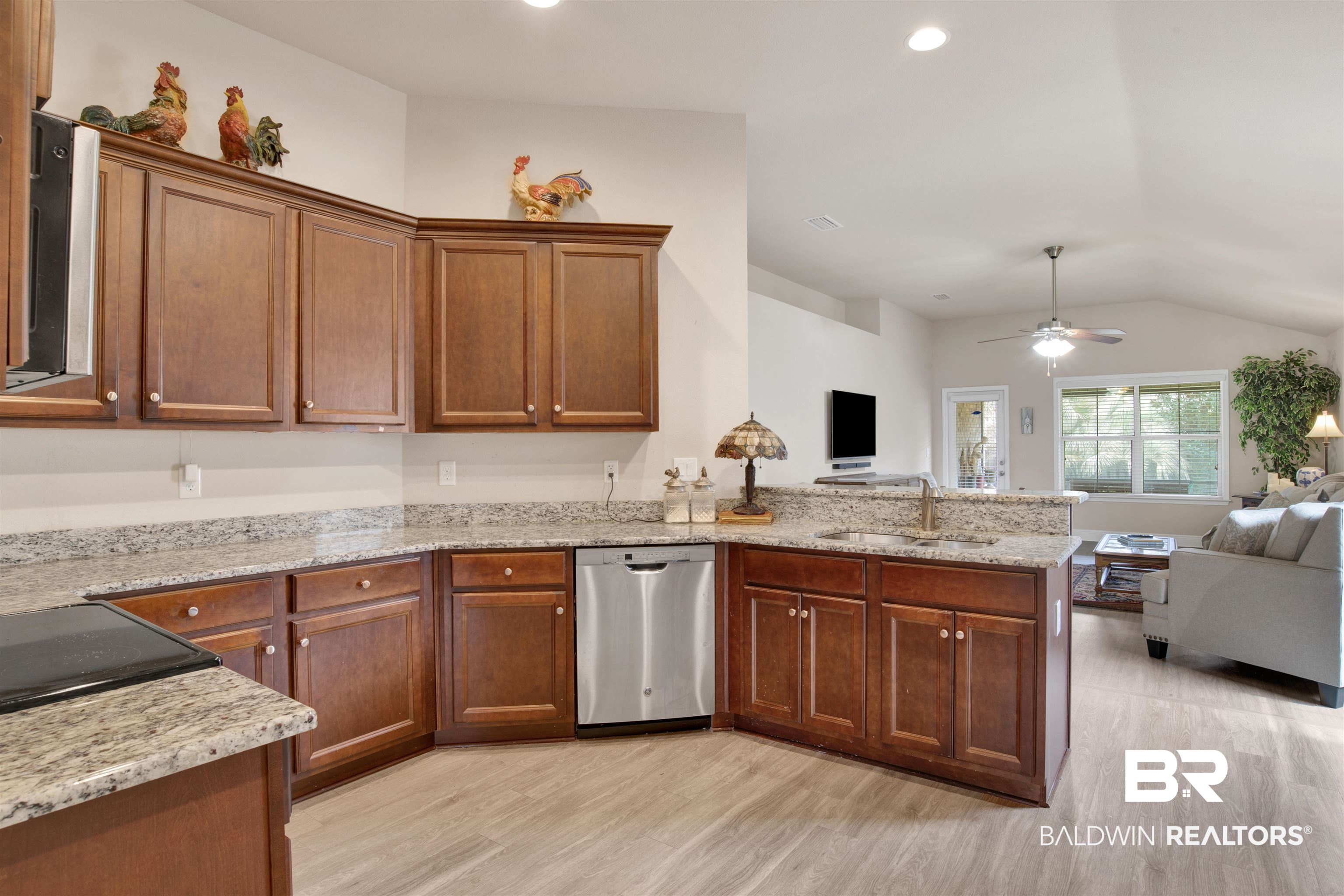 22056 Garland Loop Silverhill, AL 36576 - Photo 28 of 28 Kitchen featuring a sink, a ceiling fan, appliances with stainless steel finishes, a peninsula, and open floor plan