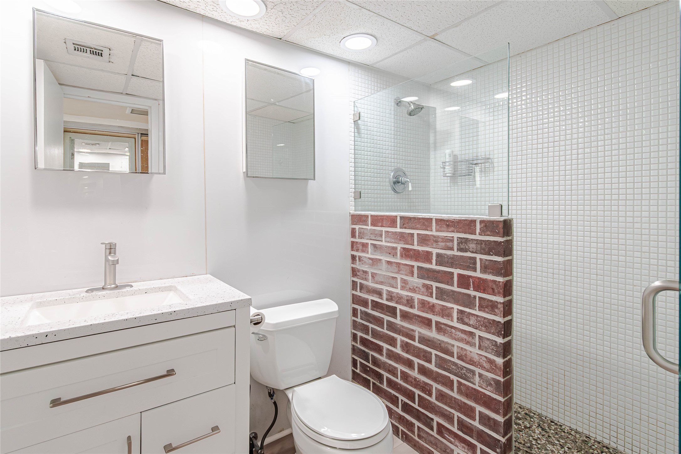 1800 Lavaca Street, Unit A705 Austin, TX 78701 - Photo 11 of 18 a bathroom with a sink a toilet a mirror and shower