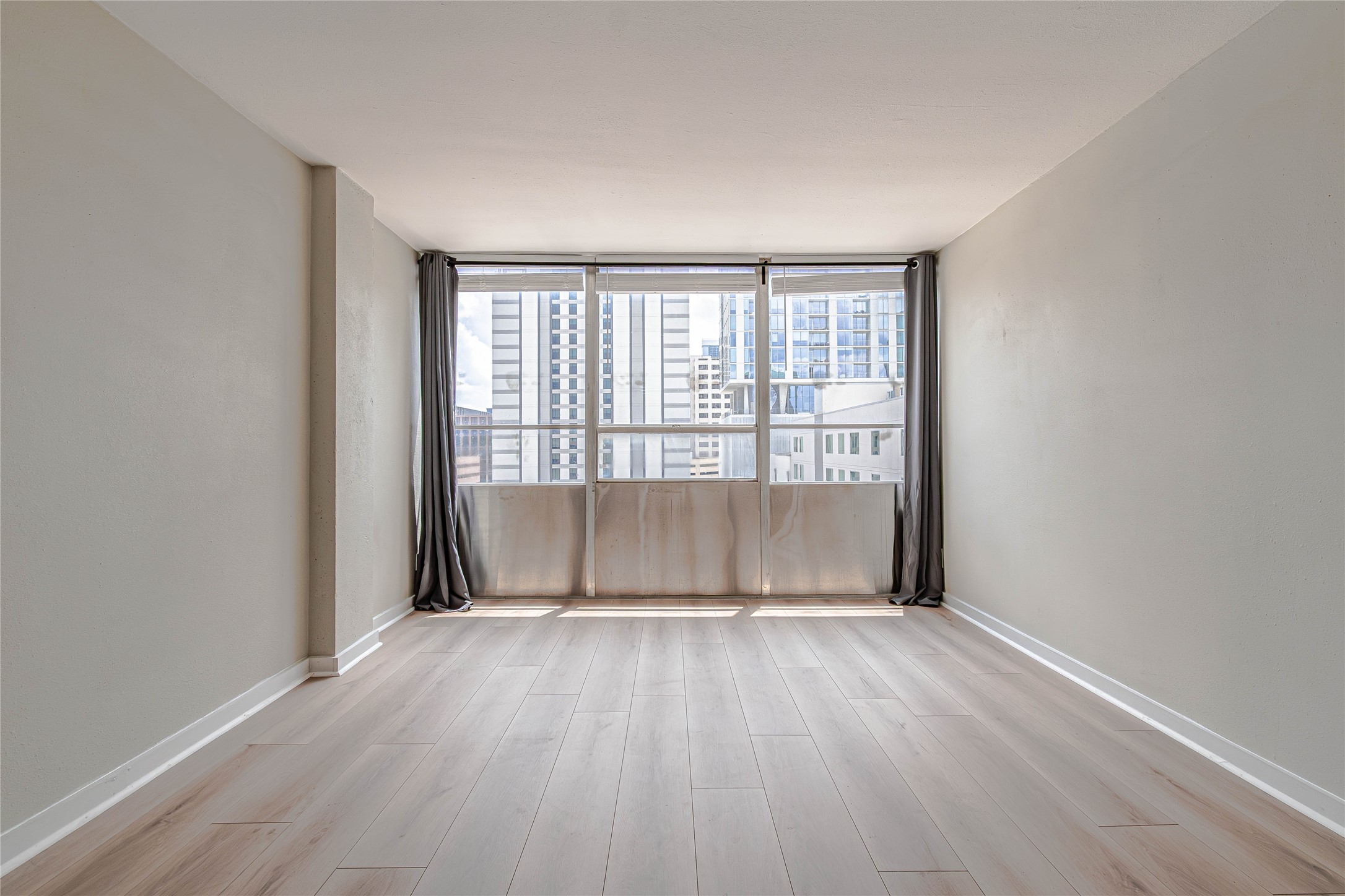 1800 Lavaca Street, Unit A705 Austin, TX 78701 - Photo 3 of 18 wooden floor in an empty room with a window
