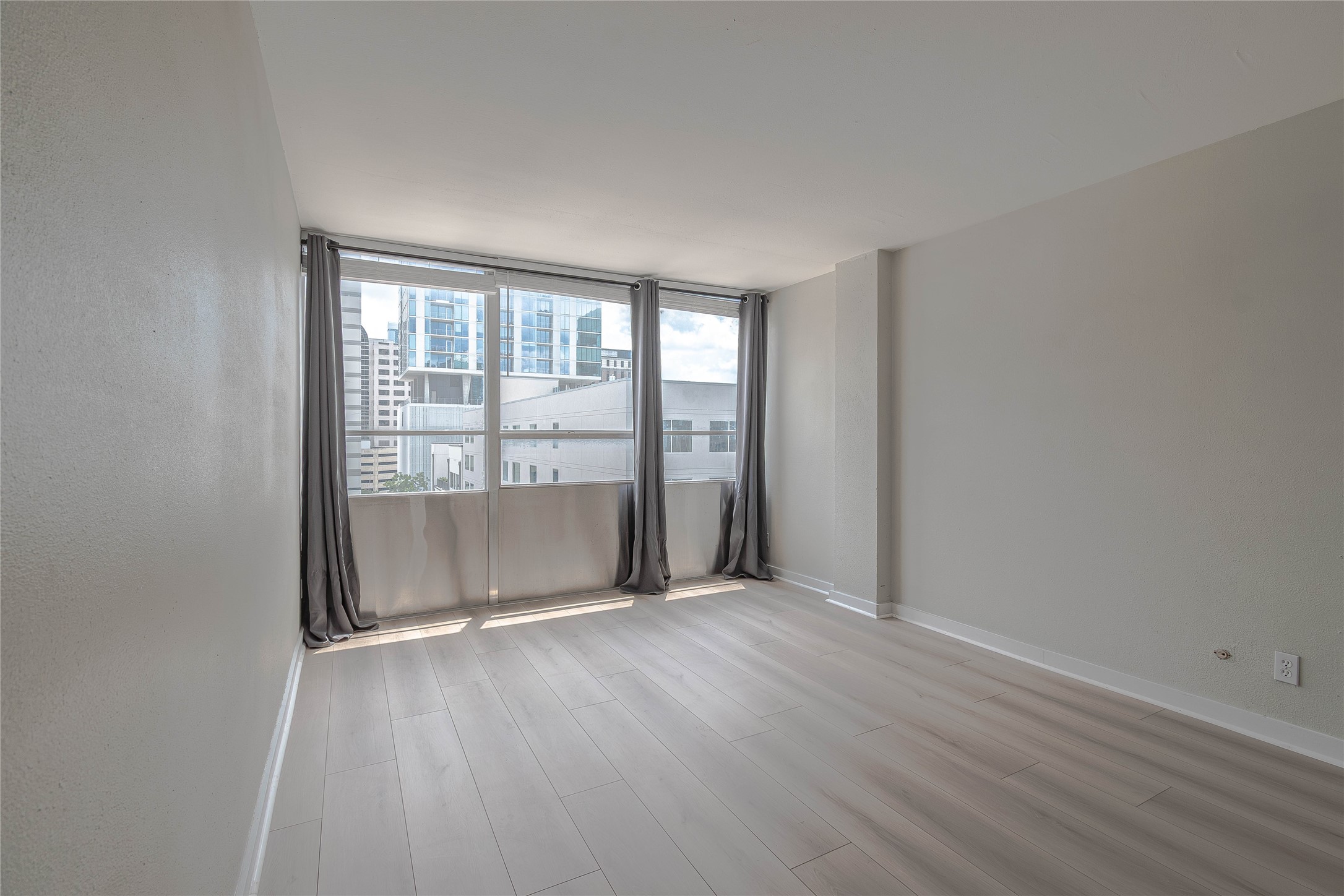 1800 Lavaca Street, Unit A705 Austin, TX 78701 - Photo 9 of 18 an empty room with wooden floor and windows