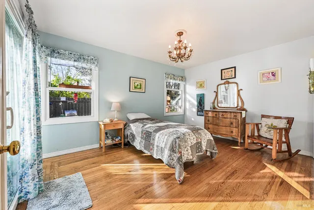 a bedroom with a bed and a chandelier