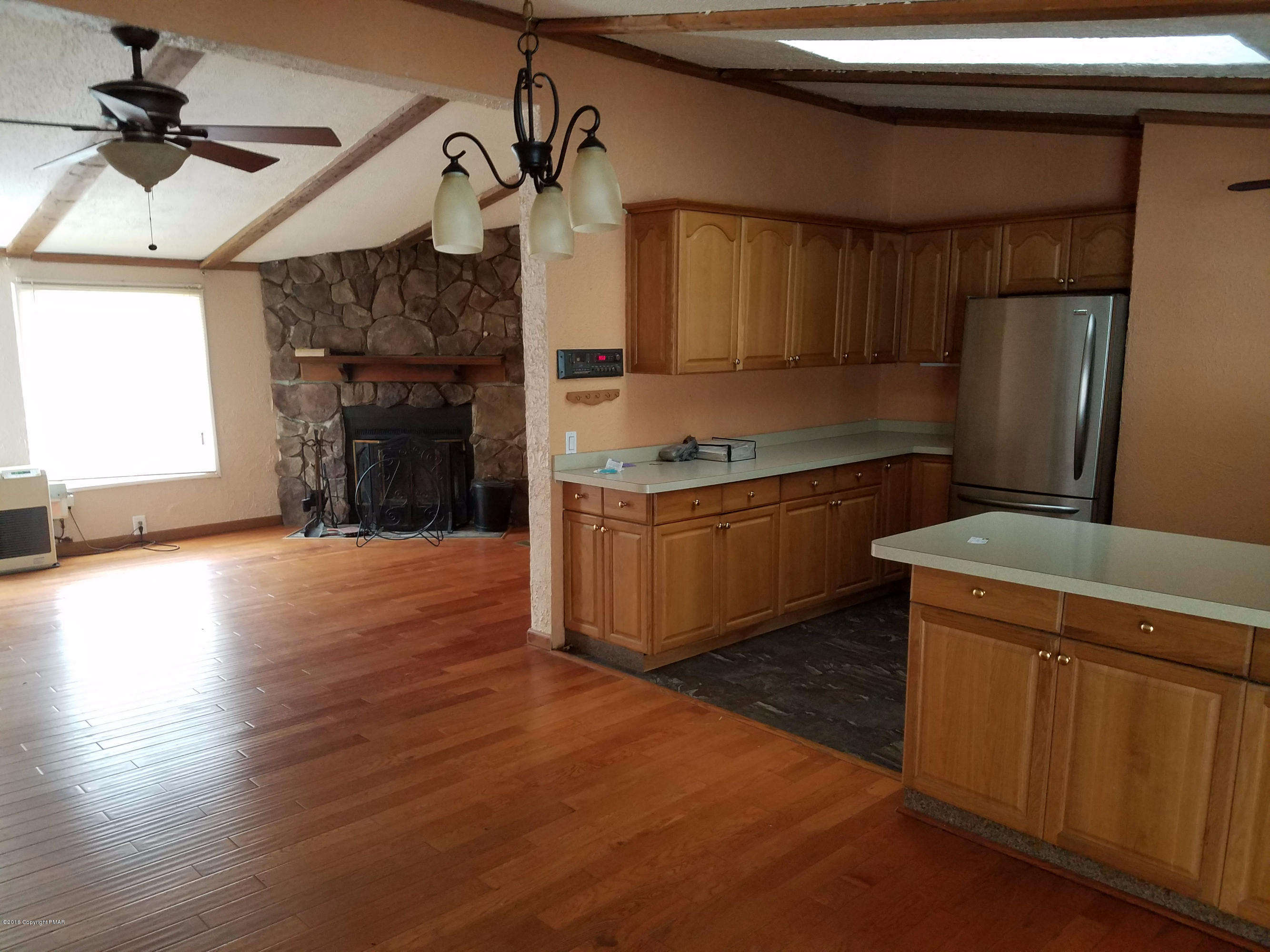 4238 Pine Ridge Drive East Bushkill, PA 18324 - Photo 8 of 19 a kitchen with stainless steel appliances granite countertop a sink a stove and a refrigerator