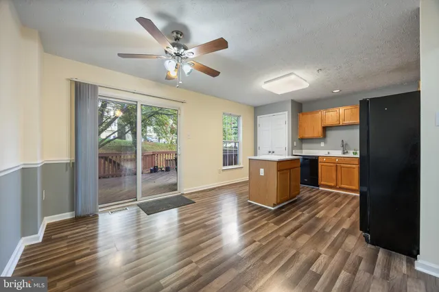 a kitchen with a wooden floor and window