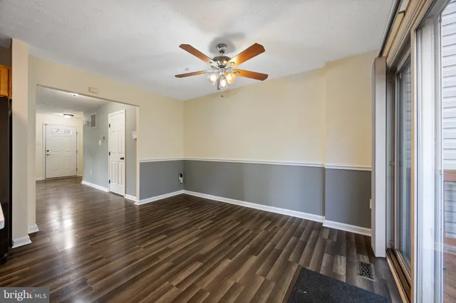 an empty room with windows and closet