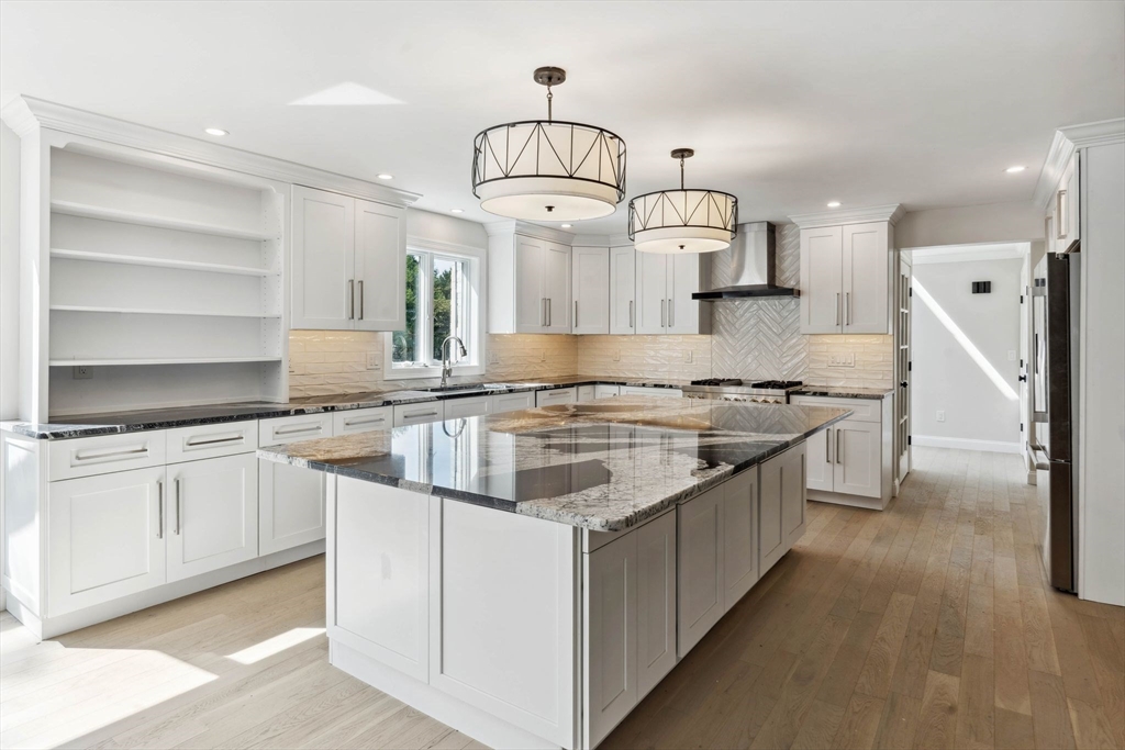 18 Pheasant Street Topsfield, MA 01983 - Photo 14 of 42 a kitchen with granite countertop a sink stove and cabinets