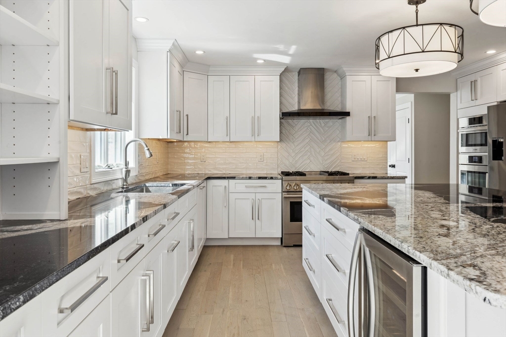 18 Pheasant Street Topsfield, MA 01983 - Photo 15 of 42 a kitchen with granite countertop a sink a counter space appliances and cabinets