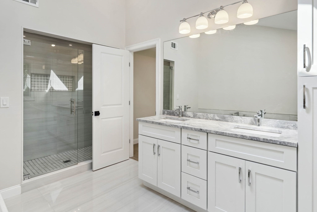 18 Pheasant Street Topsfield, MA 01983 - Photo 24 of 42 a bathroom with a granite countertop sink a large mirror and a shower
