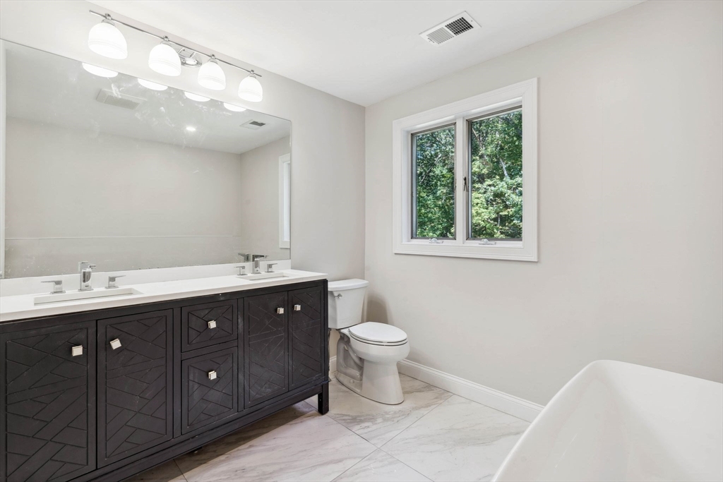 18 Pheasant Street Topsfield, MA 01983 - Photo 29 of 42 a bathroom with a toilet sink and mirror