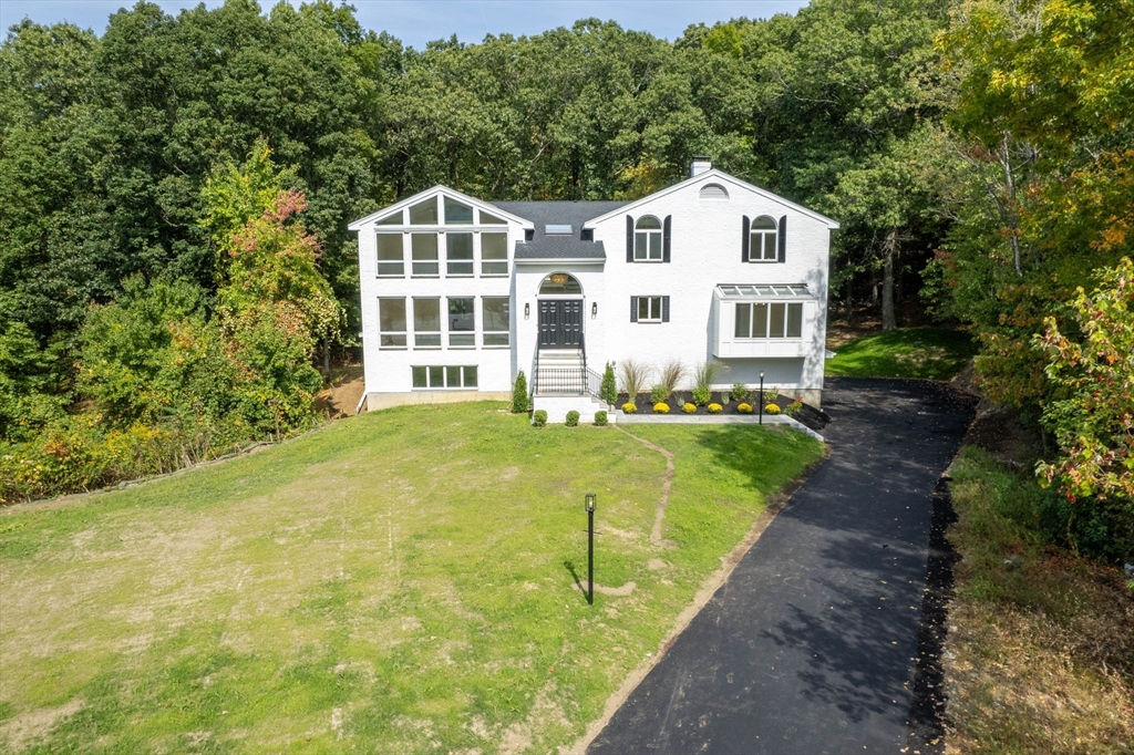 18 Pheasant Street Topsfield, MA 01983 - Photo 3 of 42 a front view of a house with a garden
