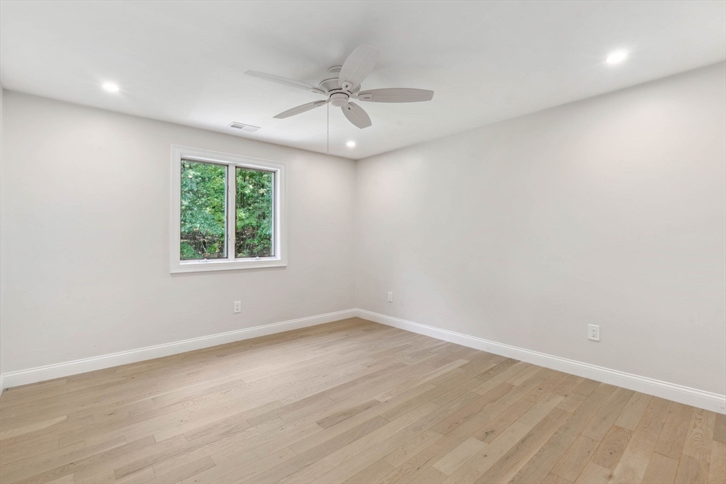 18 Pheasant Street Topsfield, MA 01983 - Photo 31 of 42 an empty room with wooden floor and windows