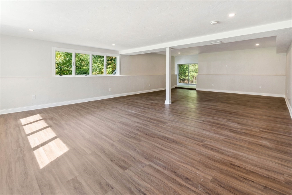18 Pheasant Street Topsfield, MA 01983 - Photo 34 of 42 an empty room with wooden floor and windows