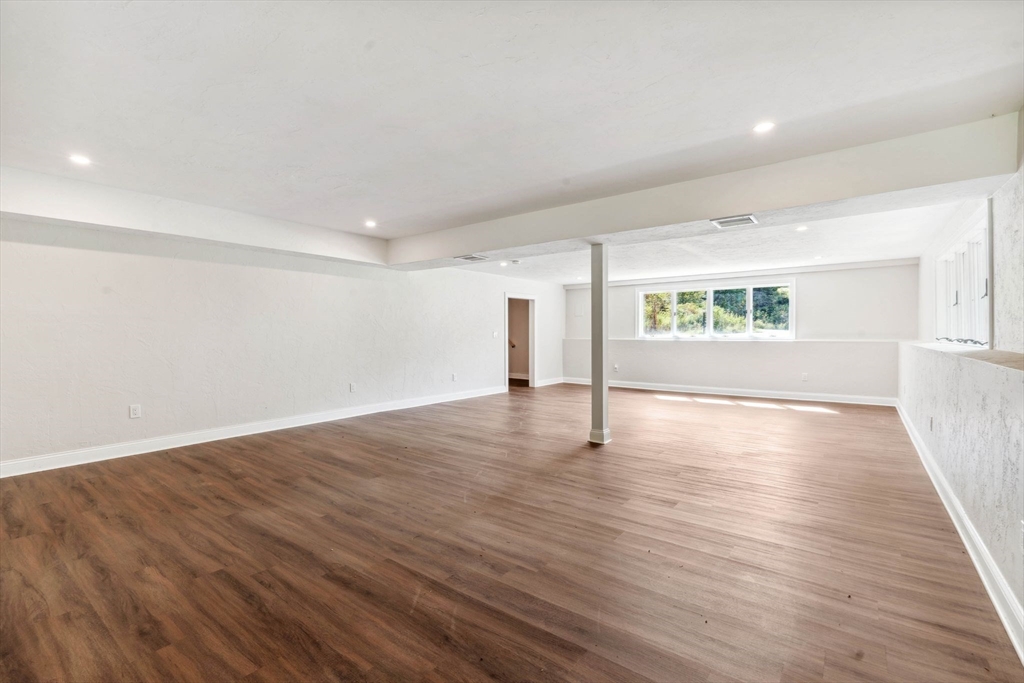 18 Pheasant Street Topsfield, MA 01983 - Photo 35 of 42 a view of empty room with wooden floor and window