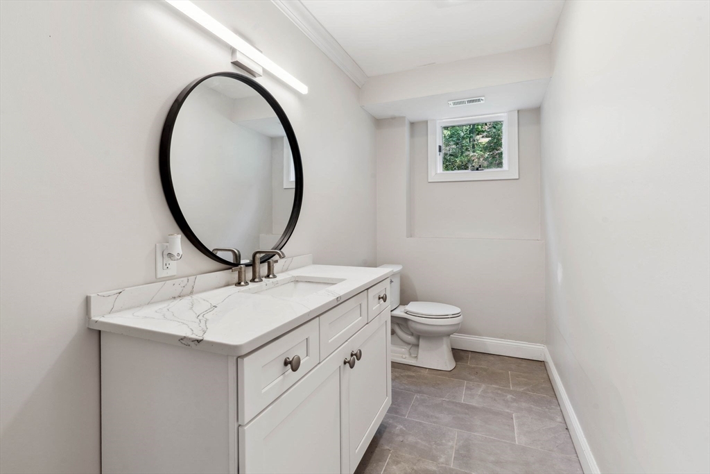 18 Pheasant Street Topsfield, MA 01983 - Photo 36 of 42 a bathroom with a toilet a sink and mirror