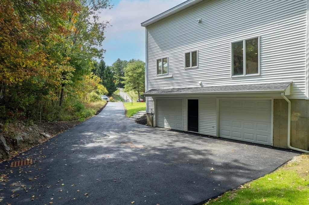 18 Pheasant Street Topsfield, MA 01983 - Photo 40 of 42 a front view of a house with a yard and garage