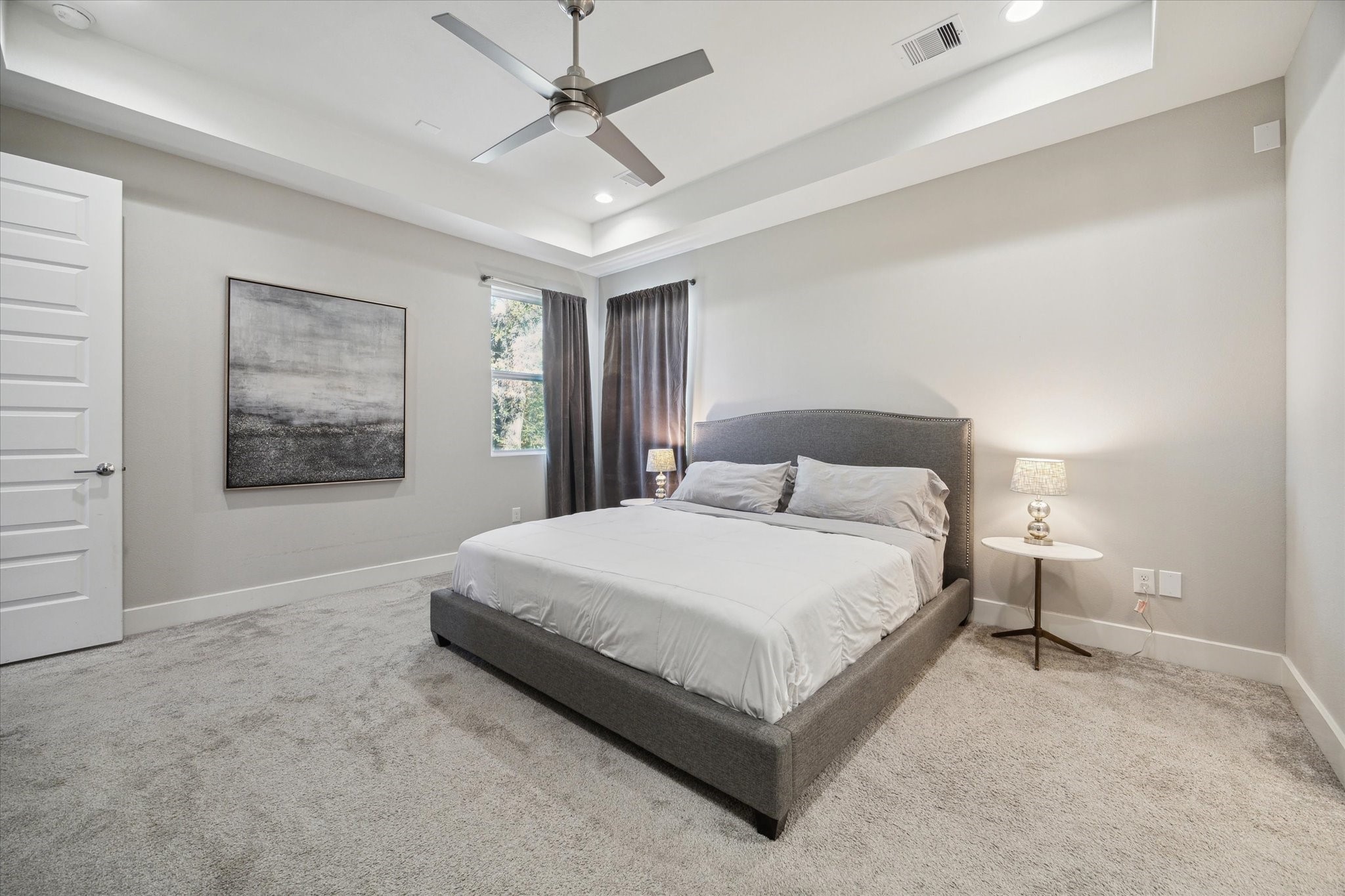 9414 Campbell Road, Unit F Houston, TX 77080 - Photo 12 of 26 a bedroom with a large bed and a chandelier