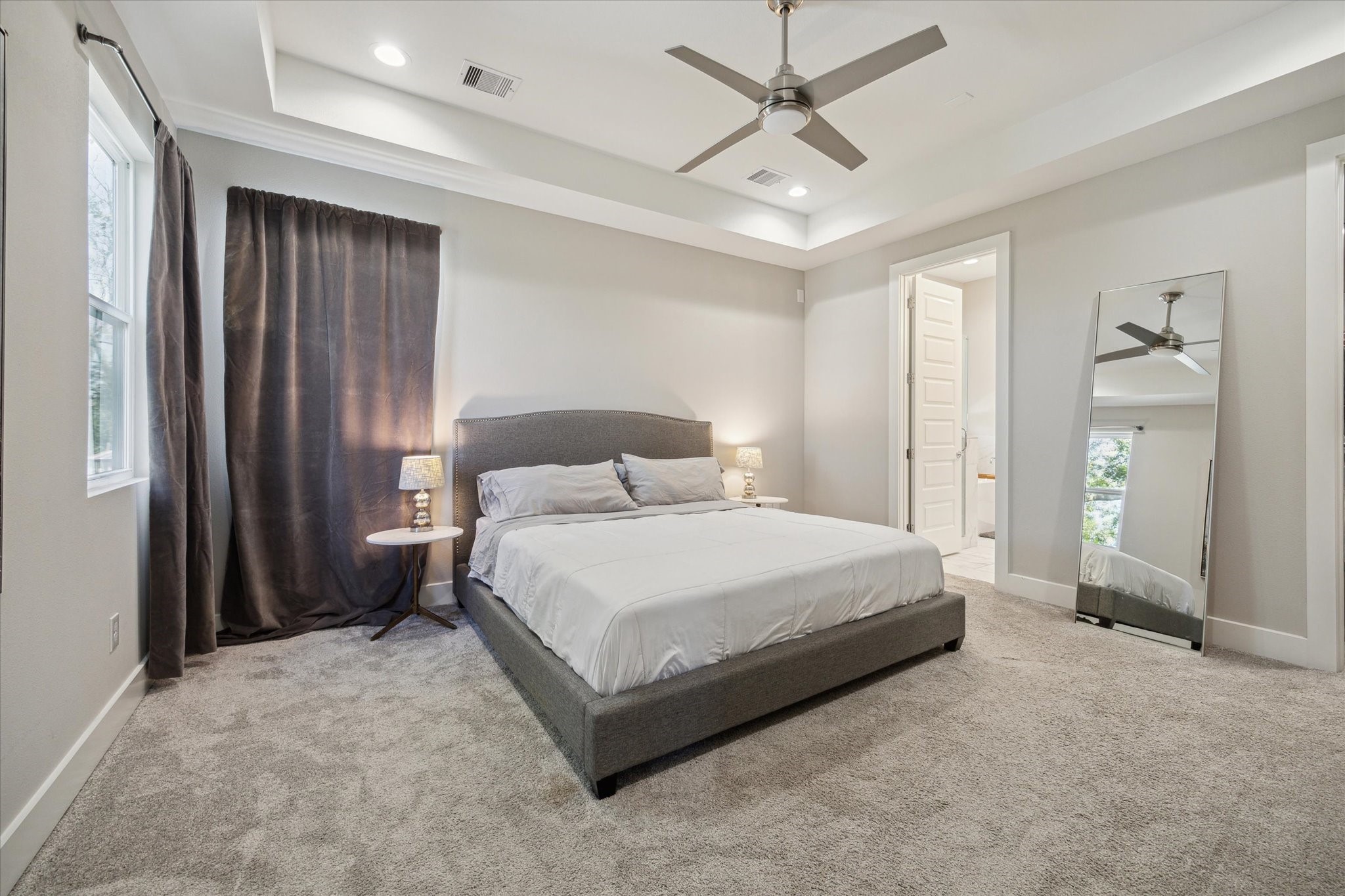 9414 Campbell Road, Unit F Houston, TX 77080 - Photo 13 of 26 a spacious bedroom with a bed and a chandelier
