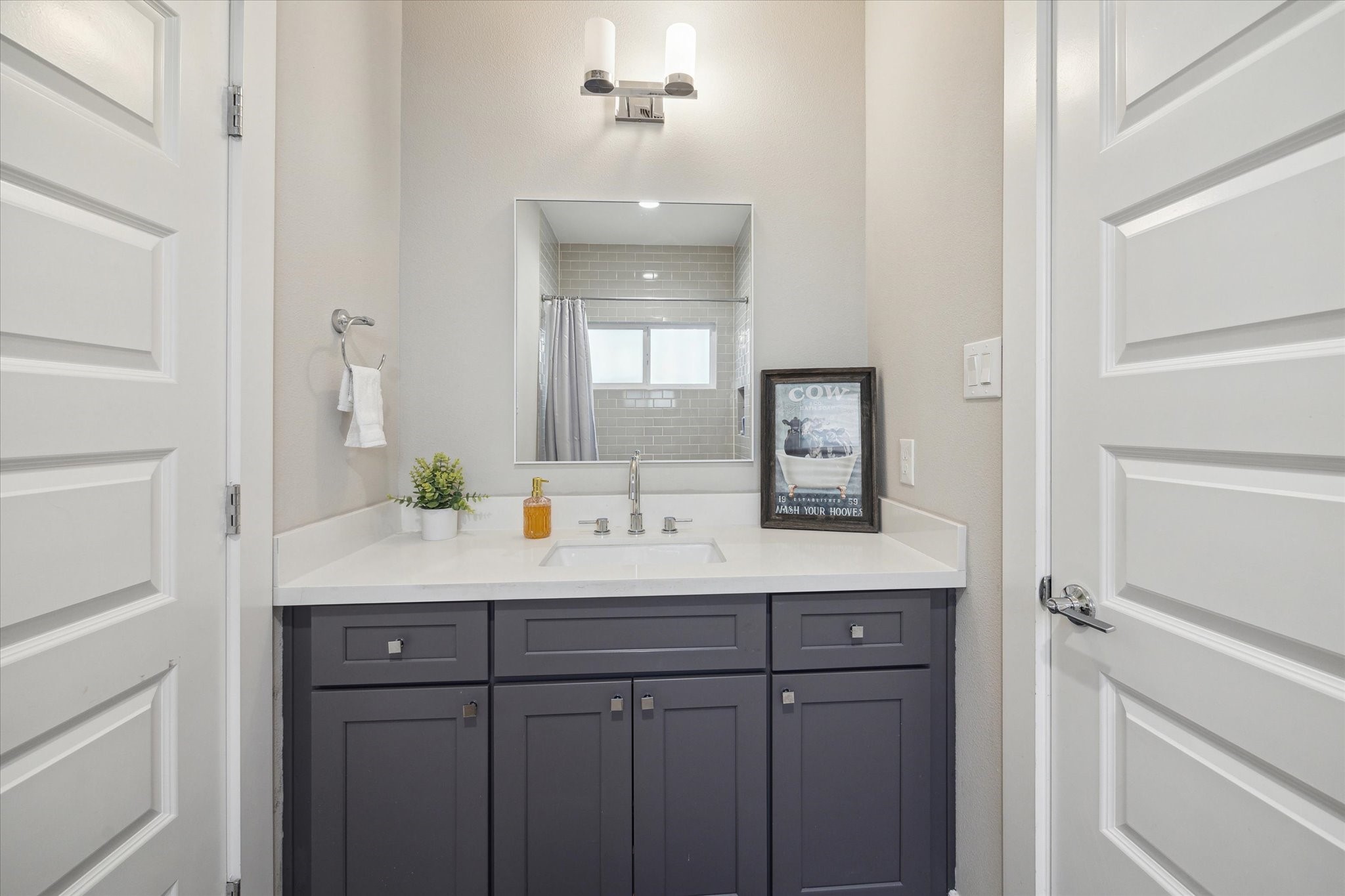 9414 Campbell Road, Unit F Houston, TX 77080 - Photo 19 of 26 a bathroom with a sink and a mirror