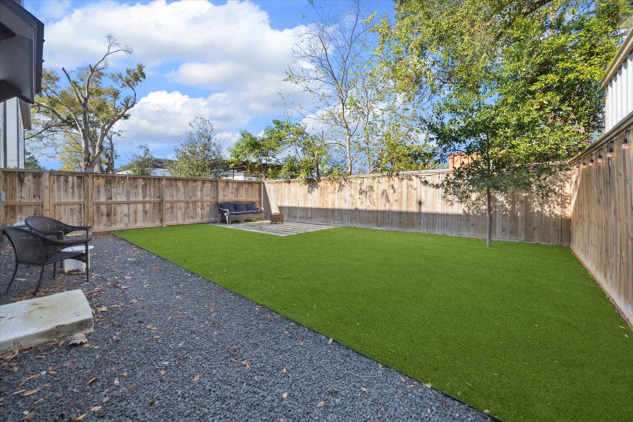 9414 Campbell Road, Unit F Houston, TX 77080 - Photo 2 of 26 a view of a yard with a bench in a garden