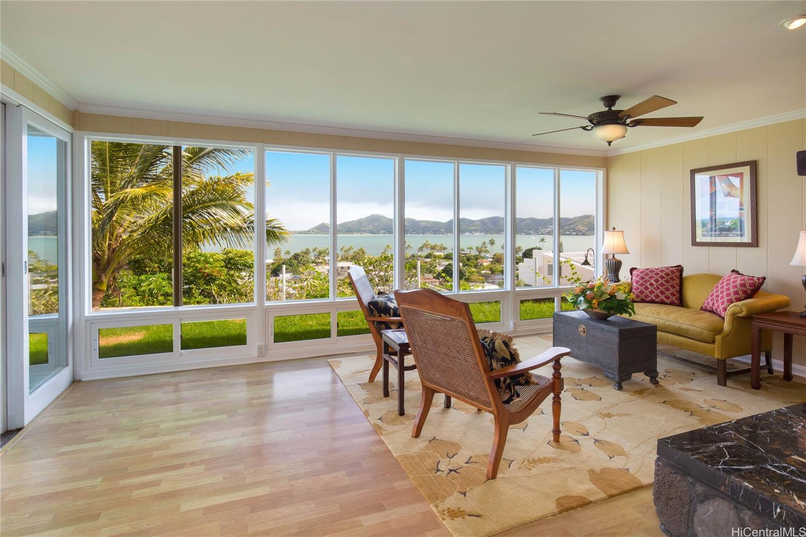 a living room filled with furniture and a floor to ceiling window