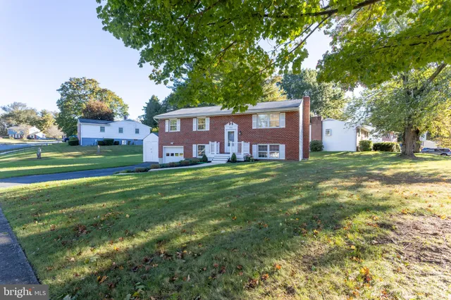 a front view of a house with a yard table and chairs