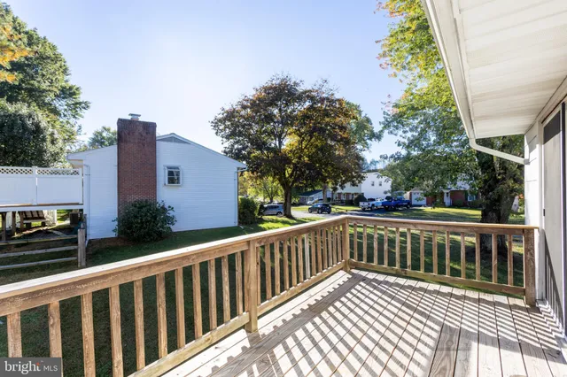 a view of balcony with wooden floor and fence