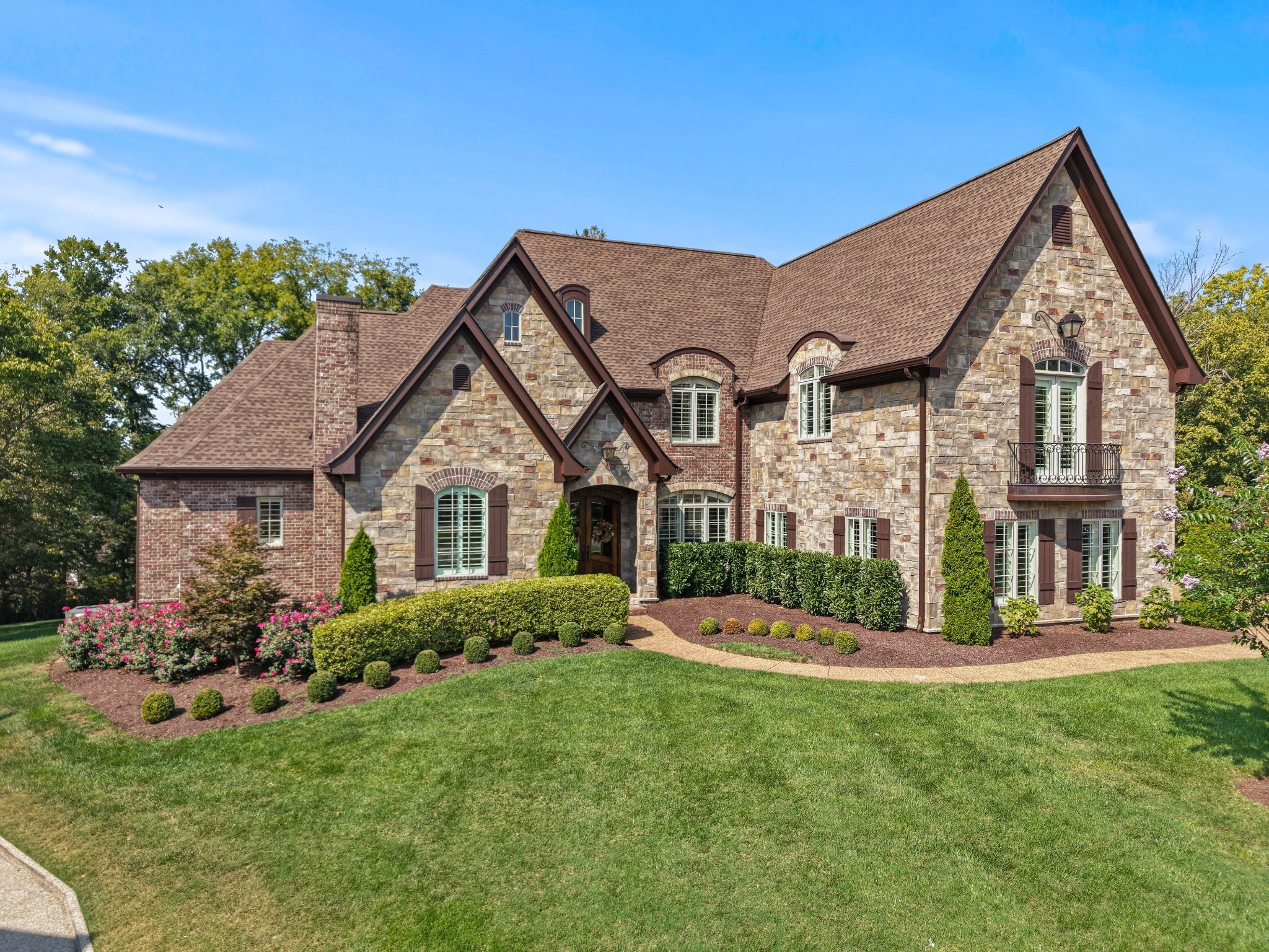 a front view of house with yard and green space