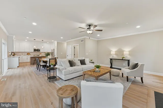 a living room with furniture and kitchen view