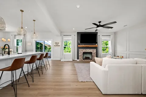 a living room with furniture a fireplace and a flat screen tv