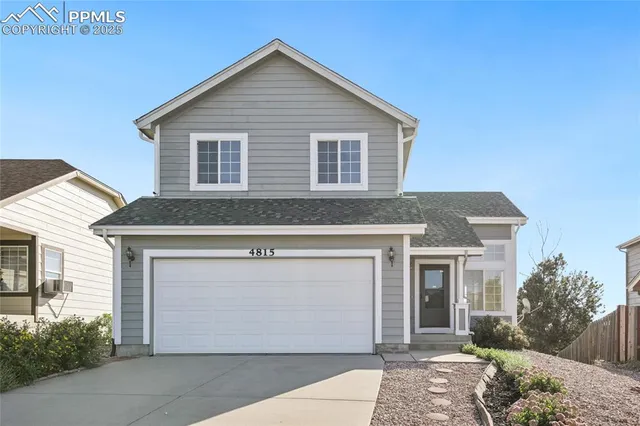 a front view of a house with a garage