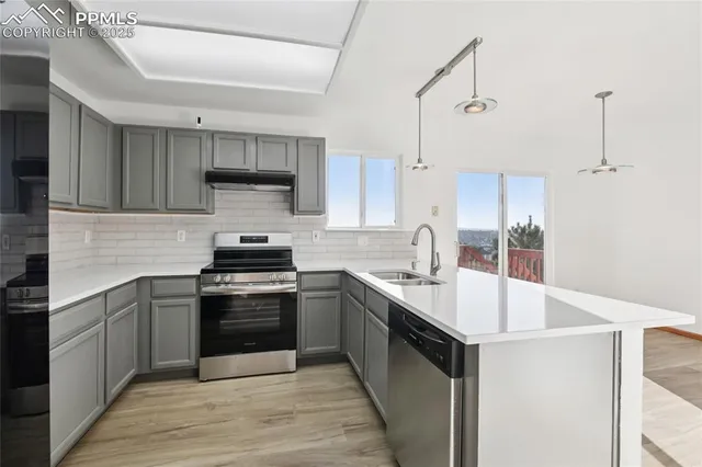 a kitchen with a sink stove and cabinets