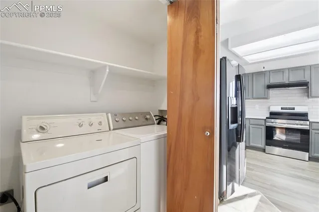 a view of storage and utility room with washer and dryer