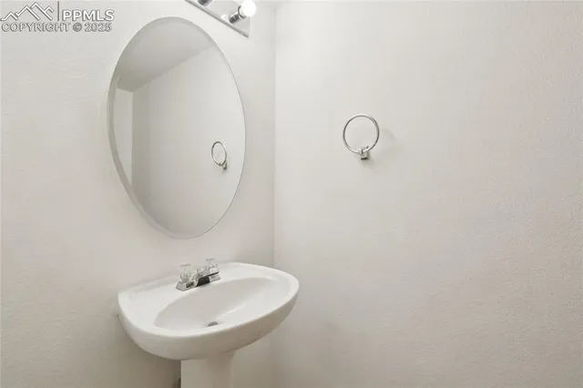 a bathroom with a sink and mirror