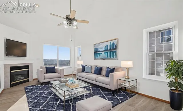 a living room with furniture a fireplace and a flat screen tv