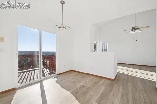 a view of a room with wooden floor and a window