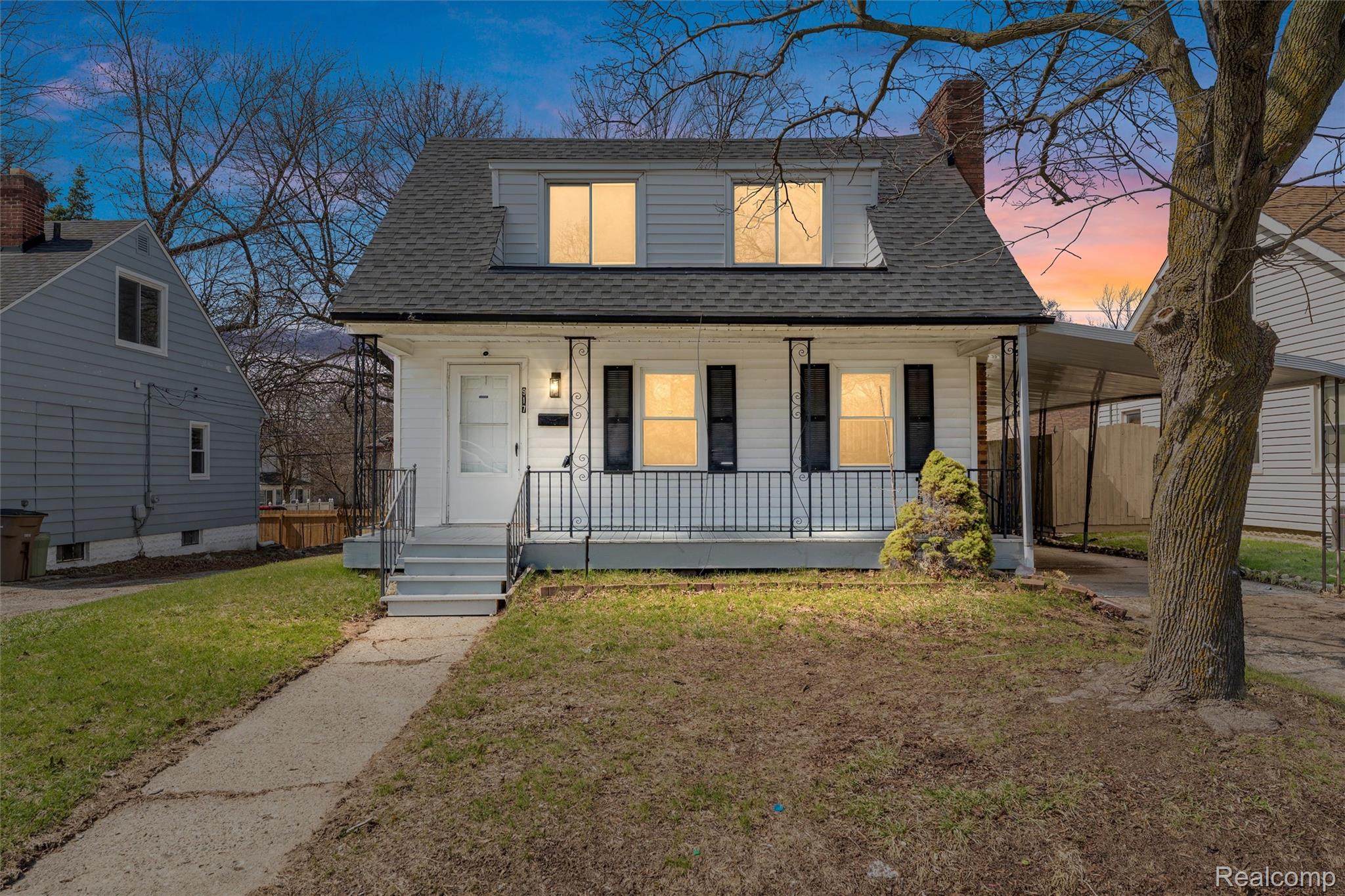 917 Perry Street Pontiac, MI 48340 - Photo 1 of 37 View of front of house featuring a front yard, a shingled roof, a porch, and a chimney