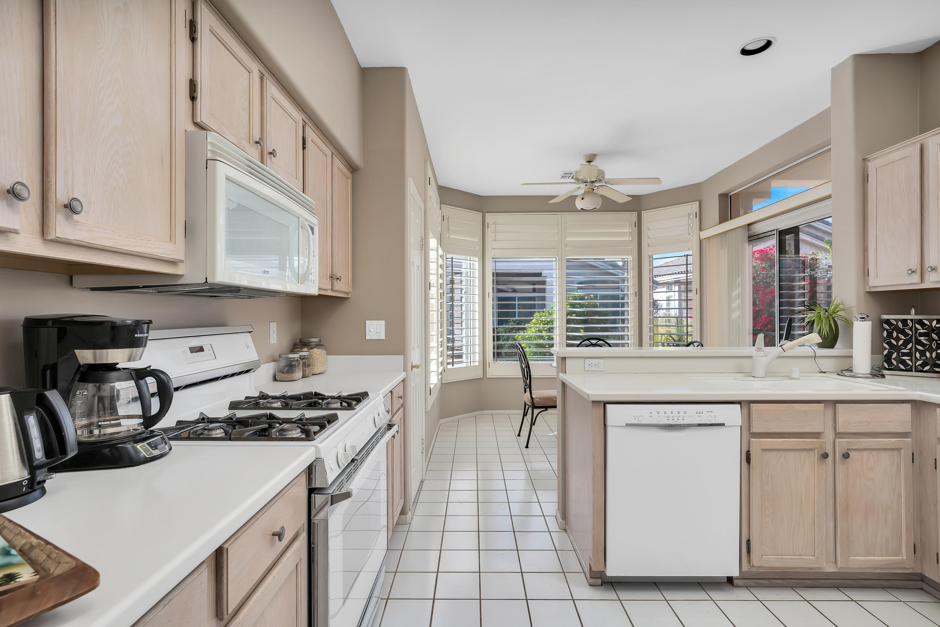 37395 Purple Shadow Road Palm Desert, CA 92211 - Photo 12 of 19 a kitchen with granite countertop a sink stove and cabinets