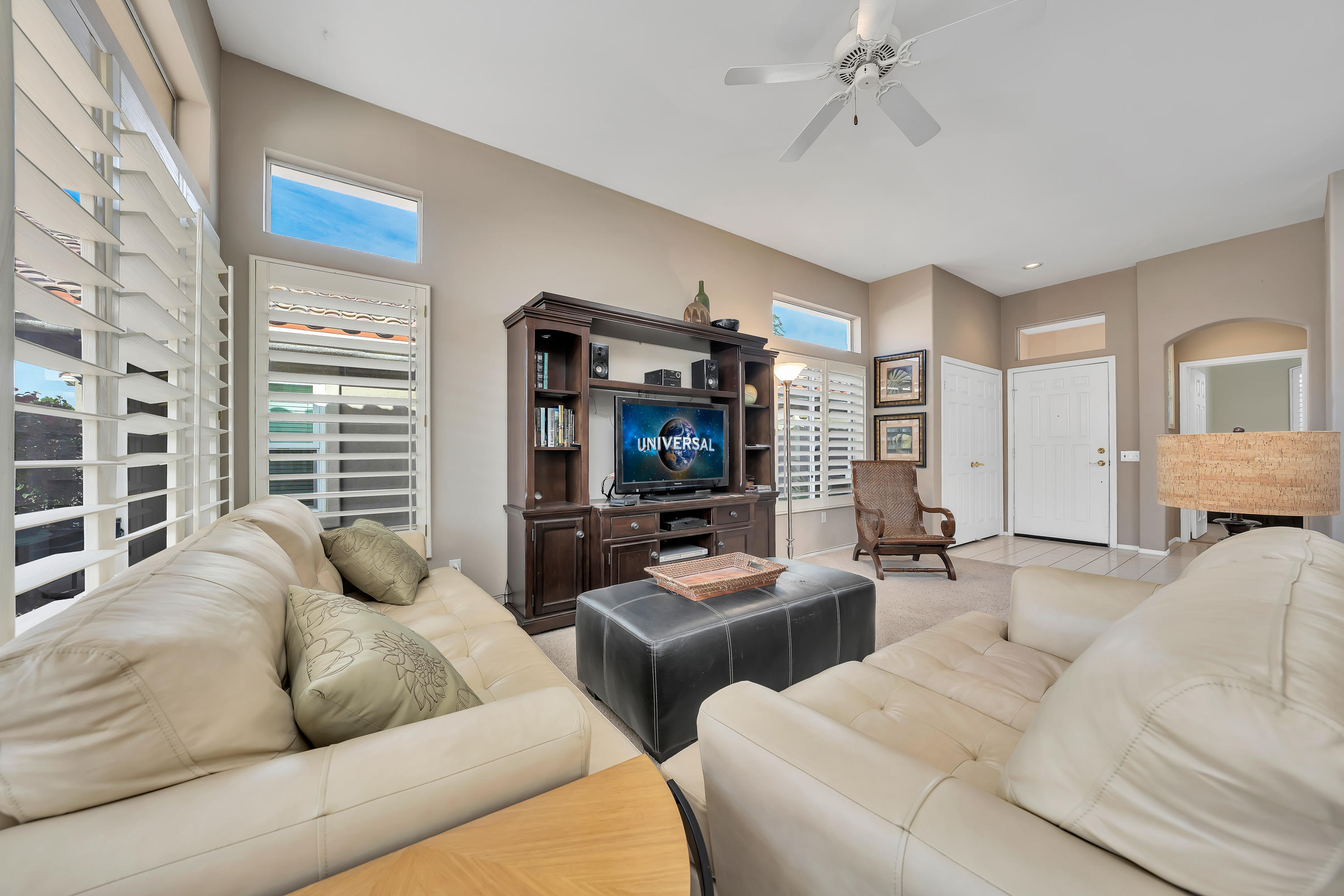 37395 Purple Shadow Road Palm Desert, CA 92211 - Photo 10 of 19 a living room with furniture a flat screen tv and a large window