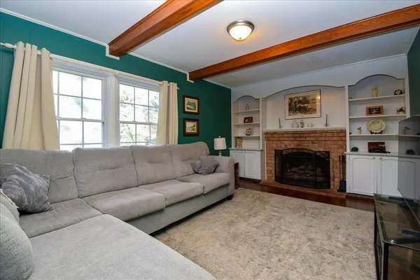 a living room with furniture a rug and a window