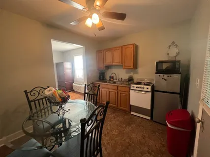 a kitchen with granite countertop a sink appliances cabinets and furniture