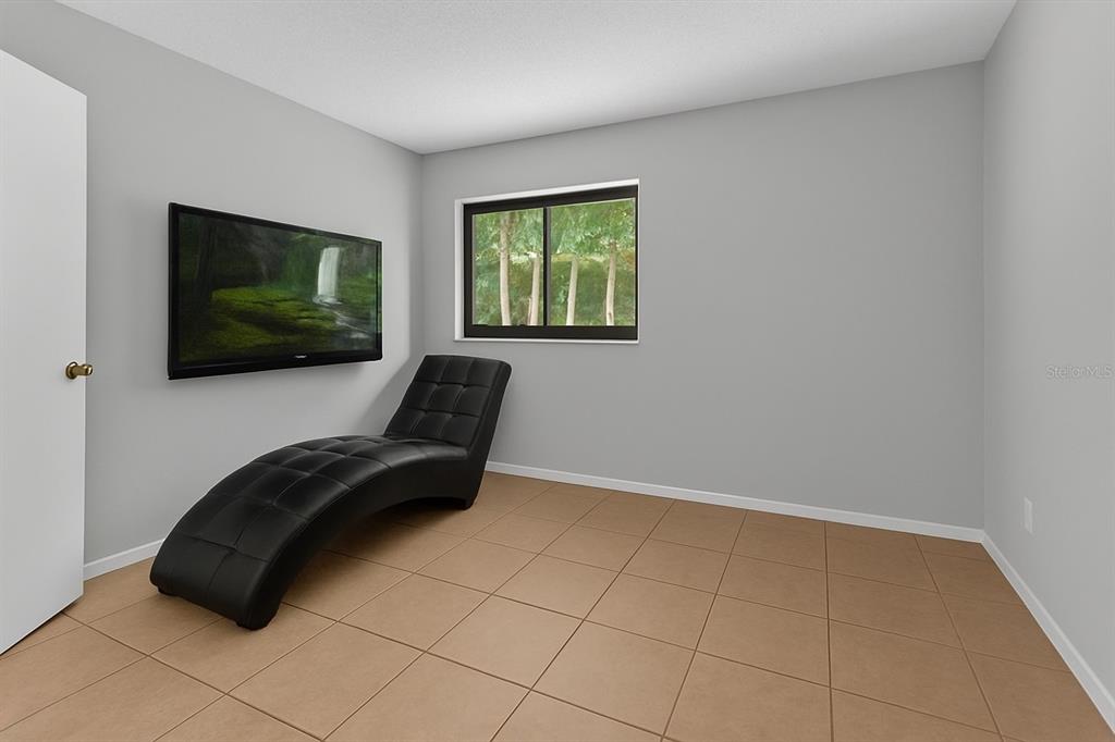 2604 Lemon Tree Lane, Unit C Orlando, FL 32839 - Photo 11 of 24 a living room with furniture and a flat screen tv