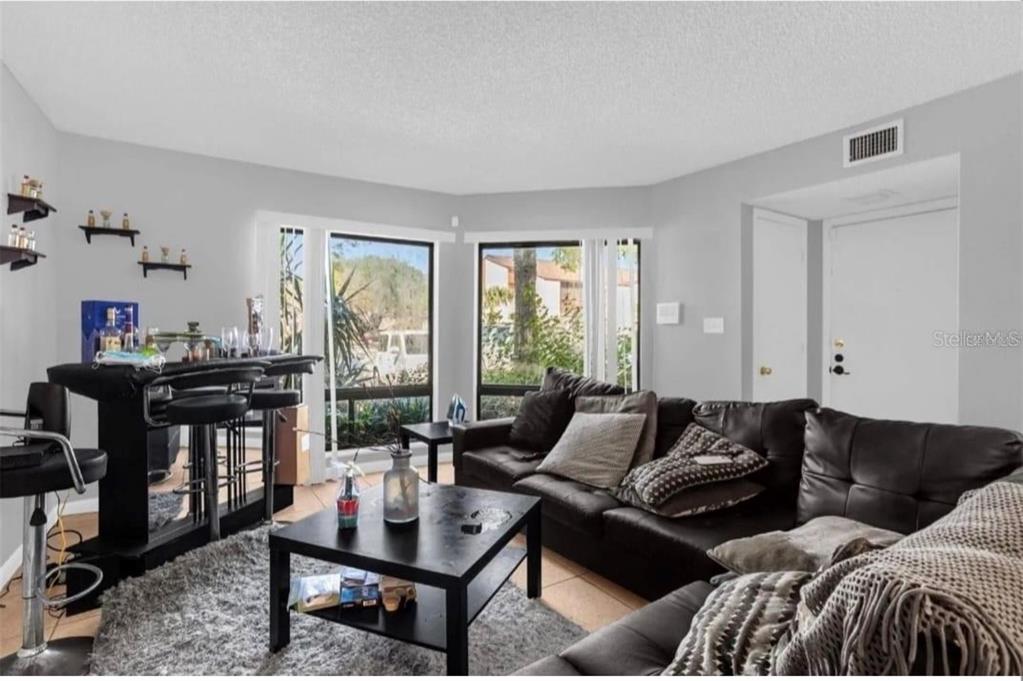 2604 Lemon Tree Lane, Unit C Orlando, FL 32839 - Photo 17 of 24 a living room with furniture and a window