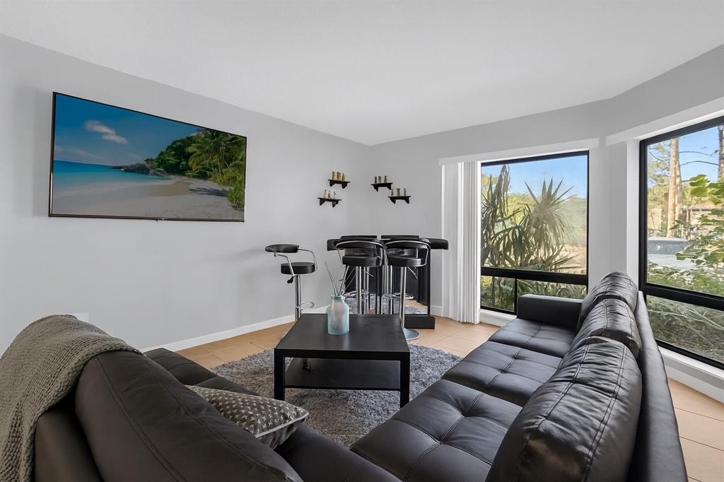 2604 Lemon Tree Lane, Unit C Orlando, FL 32839 - Photo 2 of 24 a living room with furniture and a flat screen tv