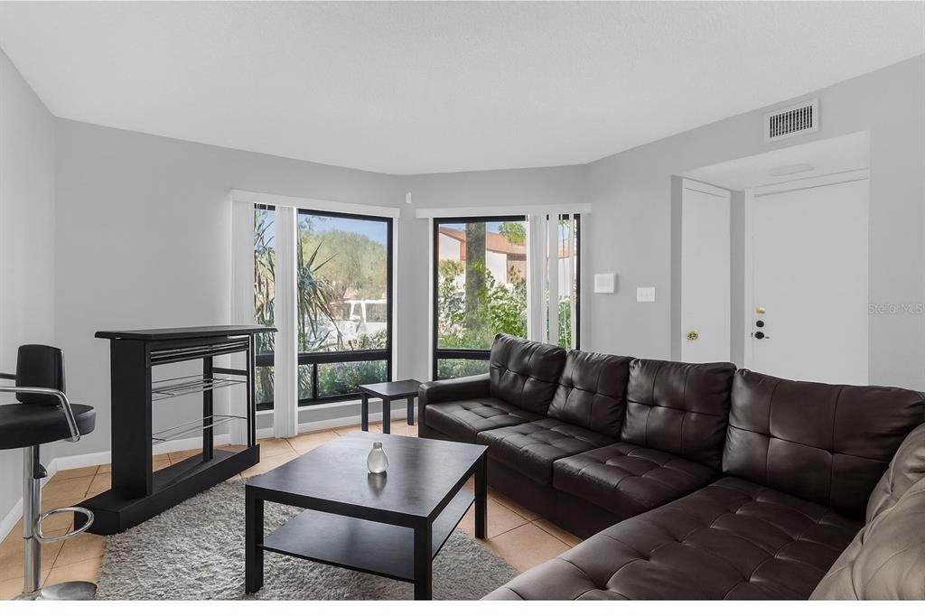 2604 Lemon Tree Lane, Unit C Orlando, FL 32839 - Photo 4 of 24 a living room with furniture and a window