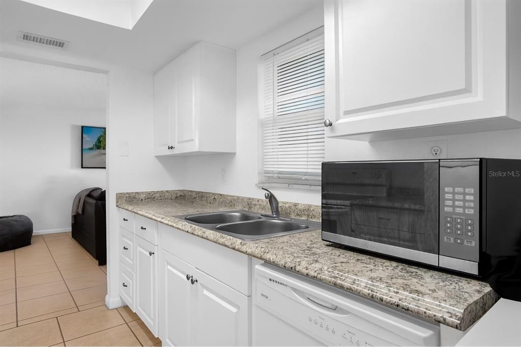 2604 Lemon Tree Lane, Unit C Orlando, FL 32839 - Photo 8 of 24 a kitchen with granite countertop a sink and cabinets