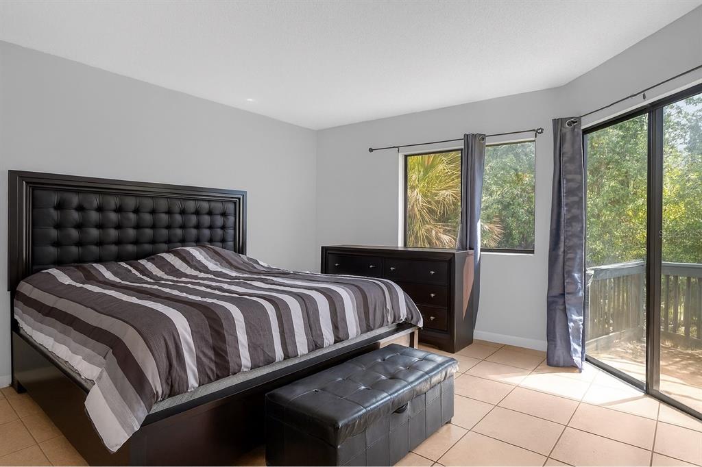 2604 Lemon Tree Lane, Unit C Orlando, FL 32839 - Photo 9 of 24 a bedroom with a bed and glass door