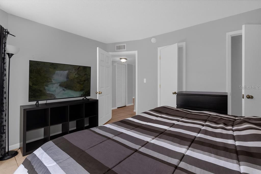 2604 Lemon Tree Lane, Unit C Orlando, FL 32839 - Photo 10 of 24 a bedroom with a bed and a flat screen tv