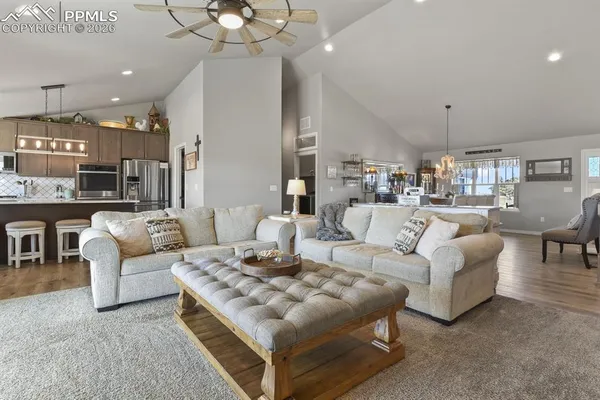 a living room with furniture and a chandelier