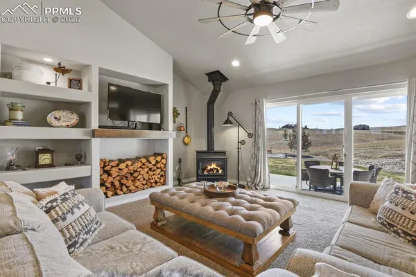 a living room with furniture a flat screen tv and a fireplace