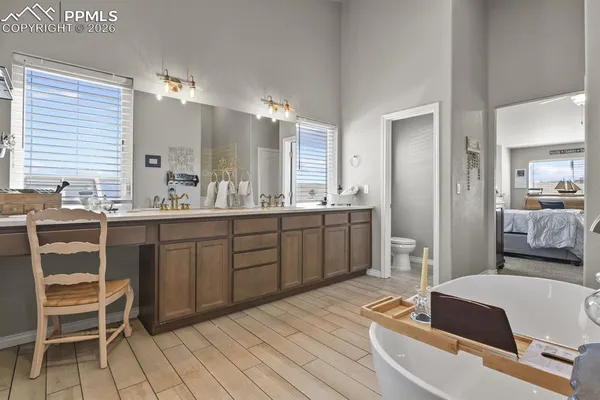 a spacious bathroom with a double vanity sink a mirror and a bathtub