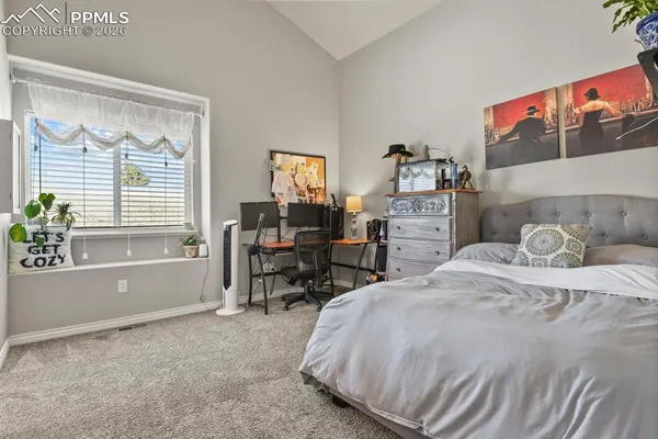 a bedroom with a bed and a table in it